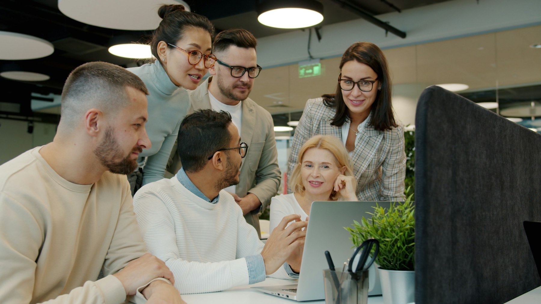 A team reviewing an AI-powered workflow together on a laptop